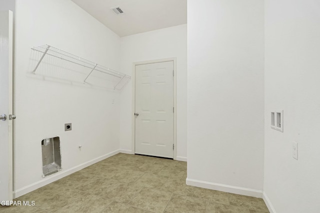 laundry room featuring laundry area, visible vents, electric dryer hookup, and baseboards