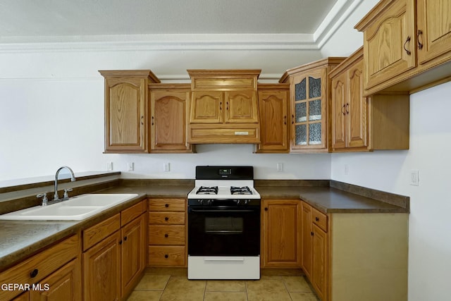 kitchen featuring dark countertops, custom range hood, glass insert cabinets, a sink, and gas range