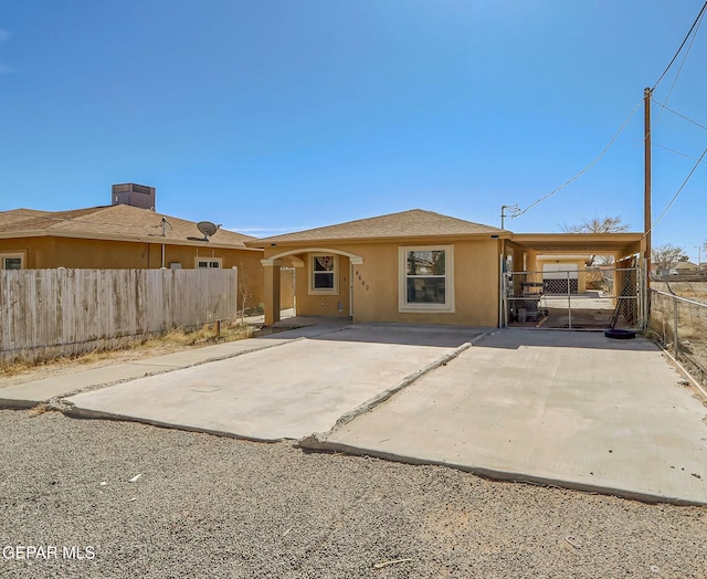 back of property featuring fence and stucco siding