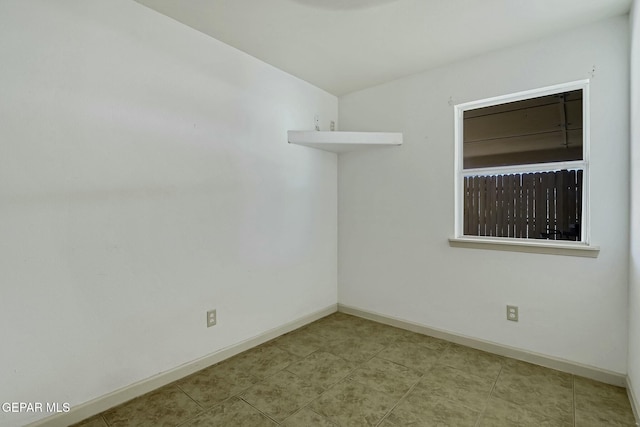 spare room with baseboards