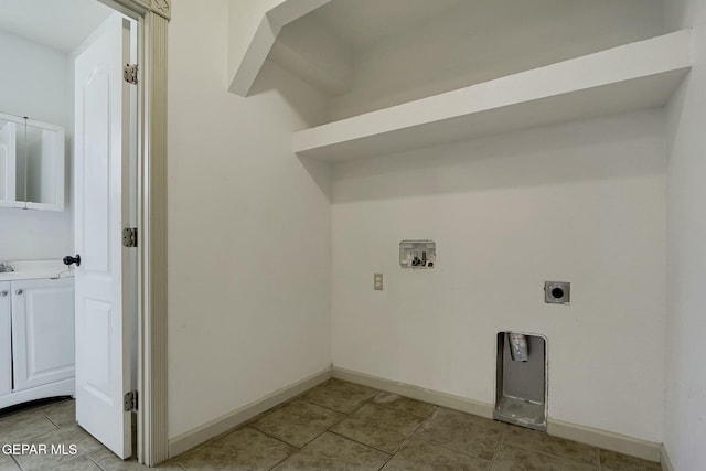 washroom with light tile patterned floors, hookup for a washing machine, hookup for an electric dryer, laundry area, and baseboards