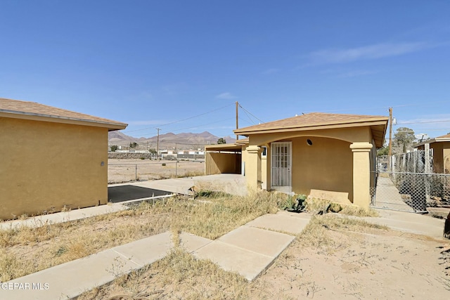 view of property exterior with fence and stucco siding