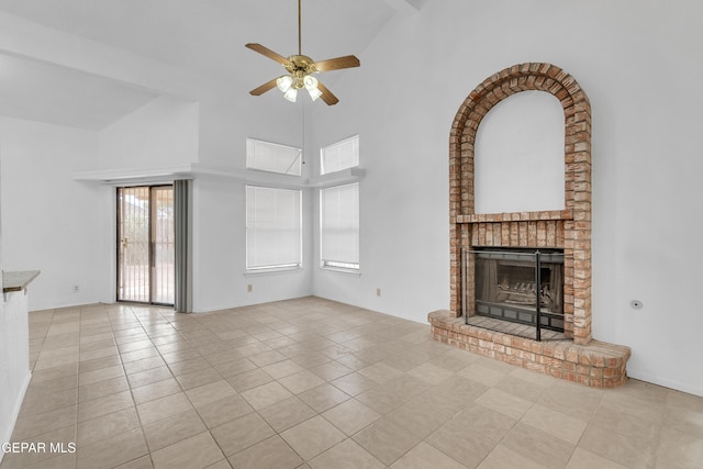 unfurnished living room with a brick fireplace, ceiling fan, light tile patterned floors, and high vaulted ceiling