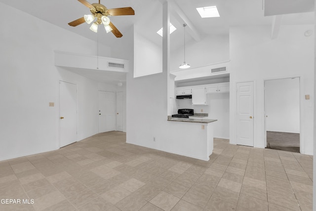 kitchen featuring a peninsula, visible vents, white cabinets, and pendant lighting