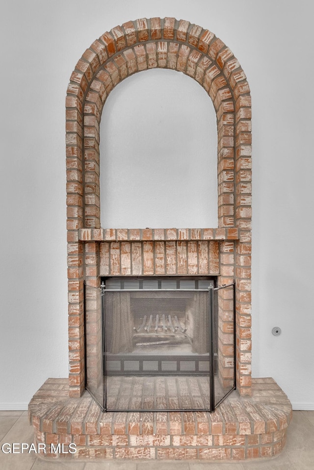 details featuring a brick fireplace