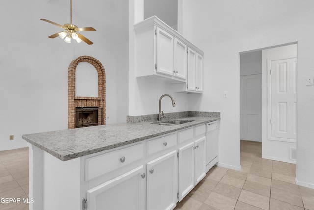 kitchen featuring dishwasher, a towering ceiling, a peninsula, white cabinetry, and a sink