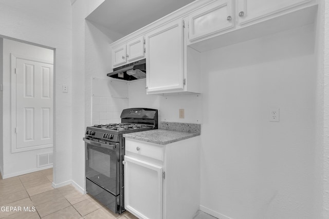 kitchen with black gas range, under cabinet range hood, visible vents, baseboards, and white cabinetry