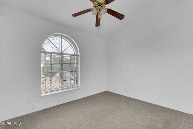 carpeted empty room featuring ceiling fan and baseboards