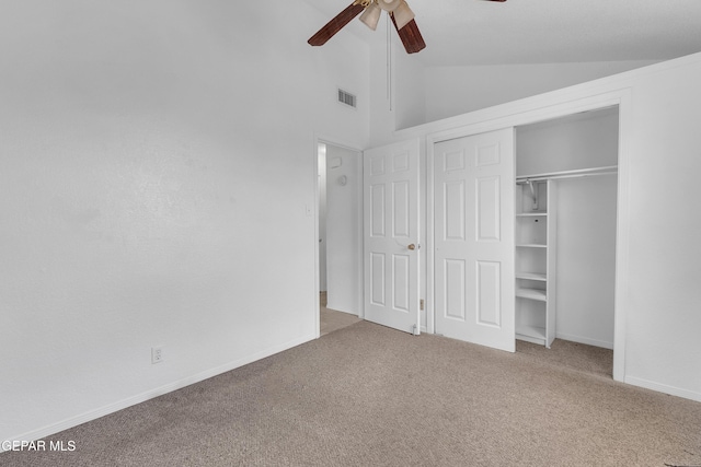 unfurnished bedroom featuring lofted ceiling, ceiling fan, carpet floors, visible vents, and a closet