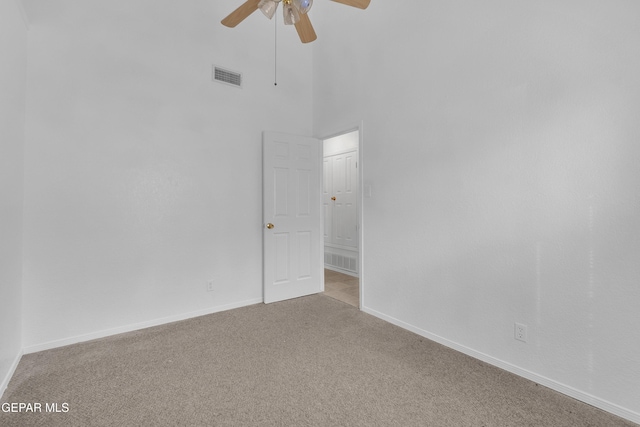 unfurnished room featuring baseboards, a ceiling fan, visible vents, and light colored carpet