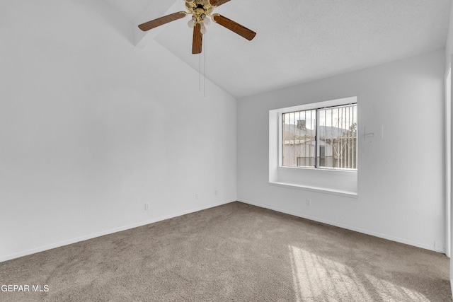 spare room featuring a ceiling fan, lofted ceiling, baseboards, and carpet