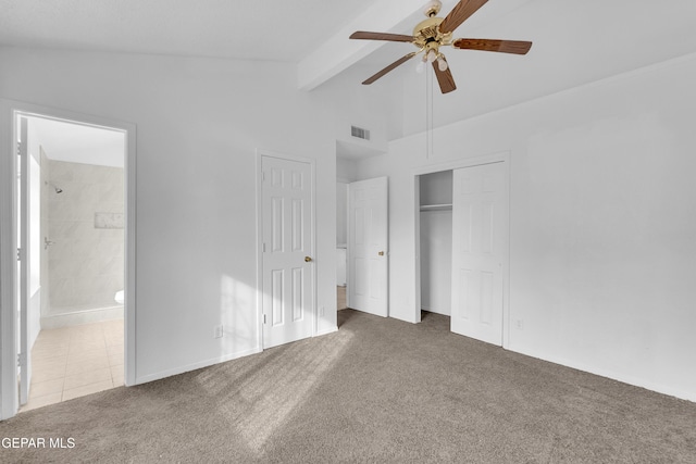 unfurnished bedroom with lofted ceiling with beams, ceiling fan, ensuite bathroom, visible vents, and carpet