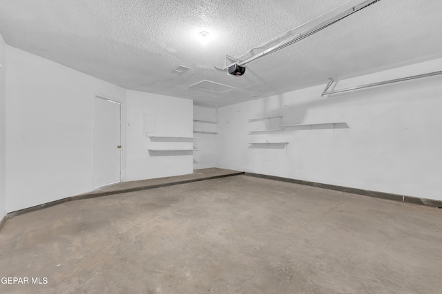 garage with a garage door opener and baseboards