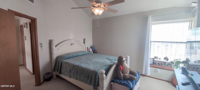 carpeted bedroom with ceiling fan, multiple windows, and vaulted ceiling