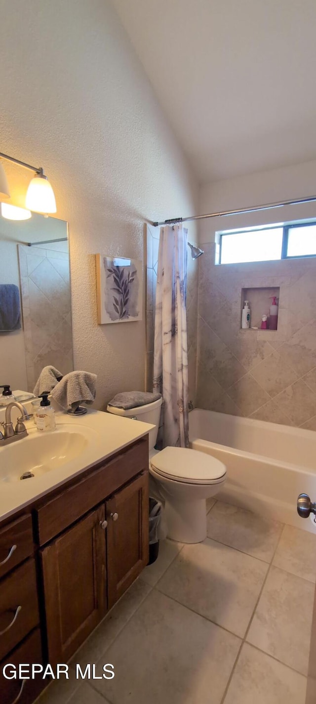 full bath featuring shower / bath combination with curtain, lofted ceiling, toilet, vanity, and tile patterned floors