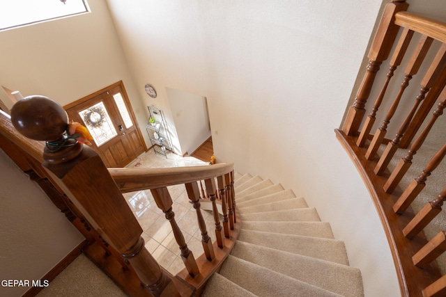 staircase featuring tile patterned flooring