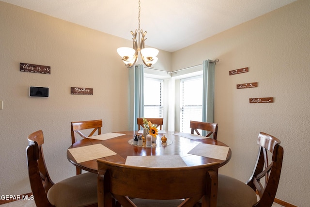 dining space featuring a notable chandelier