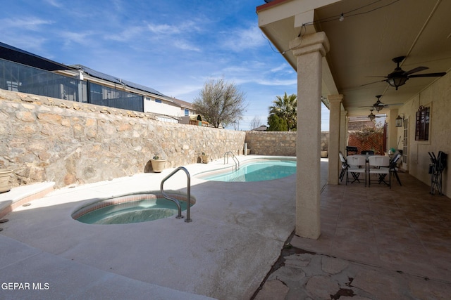 view of pool with outdoor dining area, a ceiling fan, a patio area, an in ground hot tub, and a fenced backyard