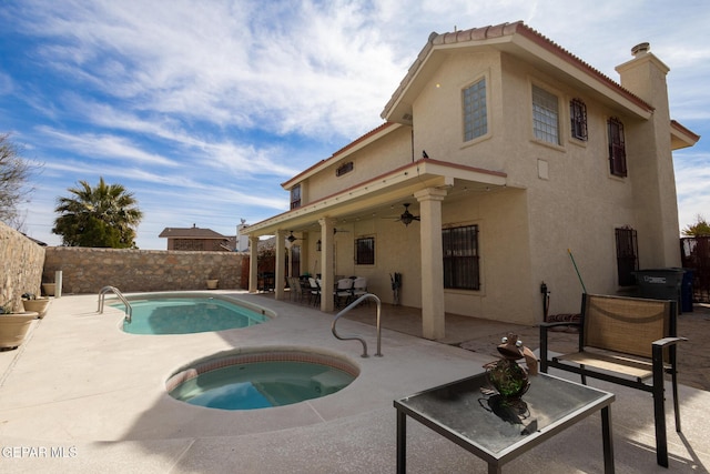 view of swimming pool with a patio, fence, a ceiling fan, and an in ground hot tub