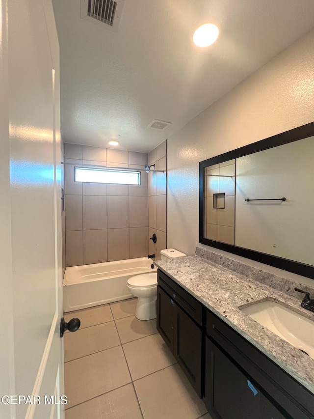 bathroom with shower / bath combination, visible vents, vanity, and tile patterned floors