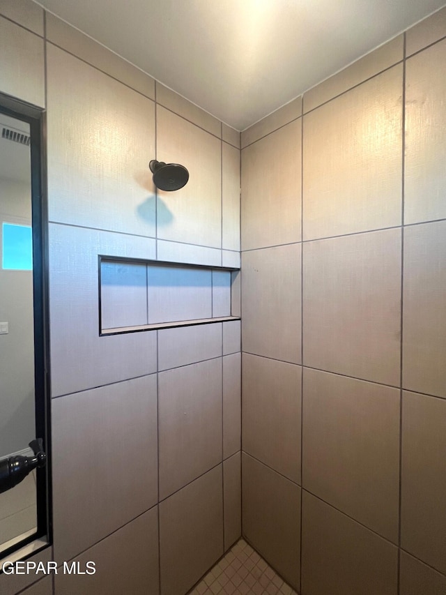 interior space with tiled shower