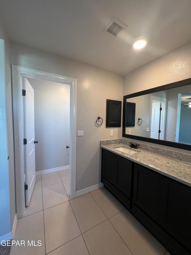 bathroom with vanity, tile patterned flooring, visible vents, and baseboards