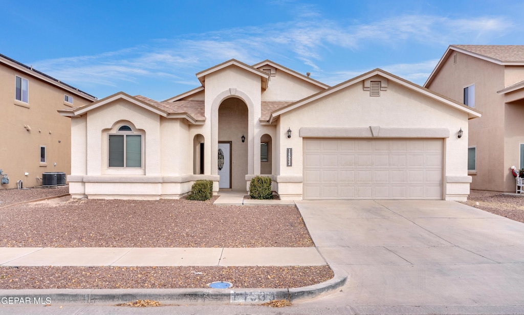 14533 Sunny Land Ave, El Paso, TX 79938 - mediterranean / spanish home with concrete driveway, central AC, an attached garage, and stucco siding
