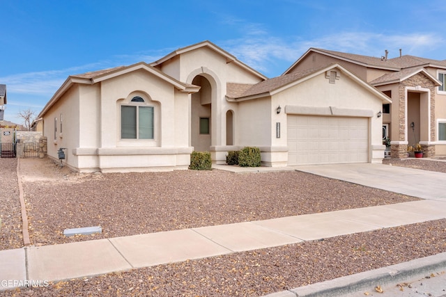 view of front of home featuring a garage, driveway, and stucco siding