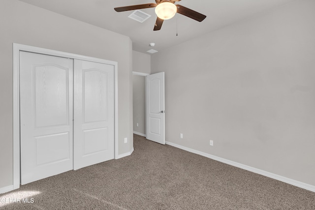 unfurnished bedroom featuring carpet floors, a closet, visible vents, a ceiling fan, and baseboards