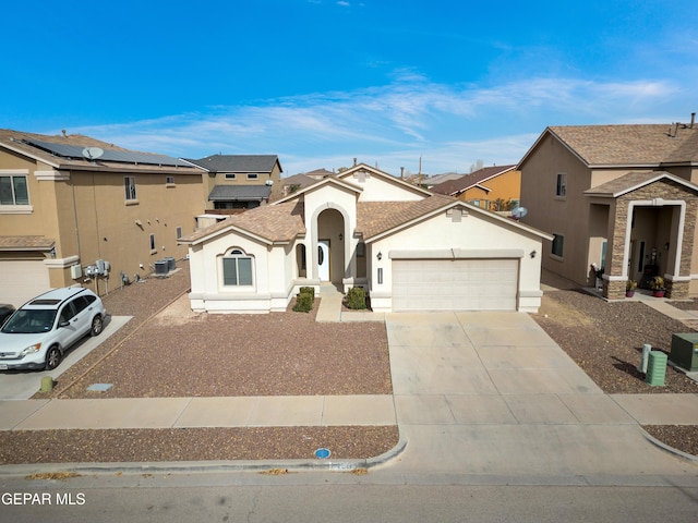 view of front of home featuring a garage, a residential view, concrete driveway, and stucco siding