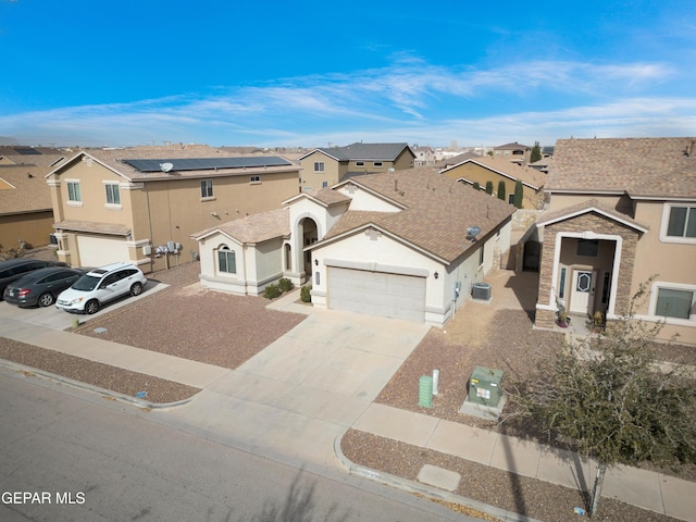 view of property with driveway, a residential view, and stucco siding