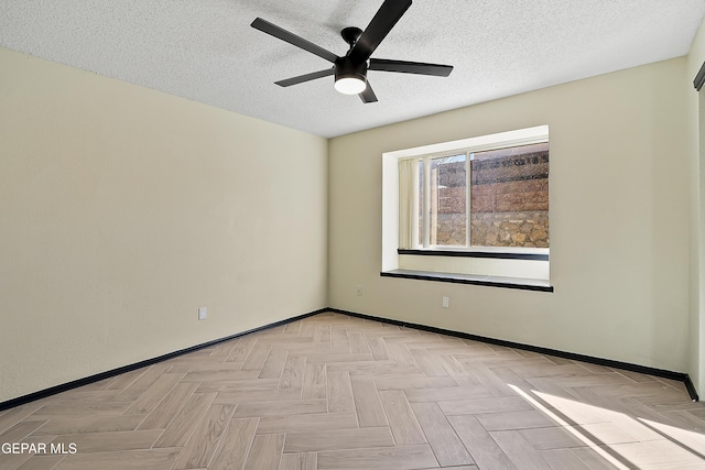 unfurnished room with a ceiling fan, baseboards, and a textured ceiling