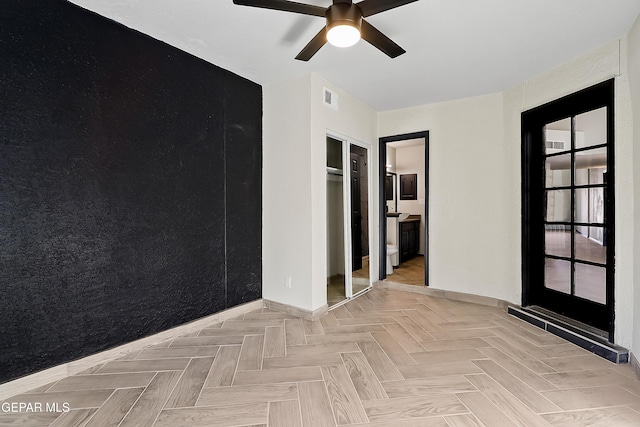 empty room with a ceiling fan and visible vents