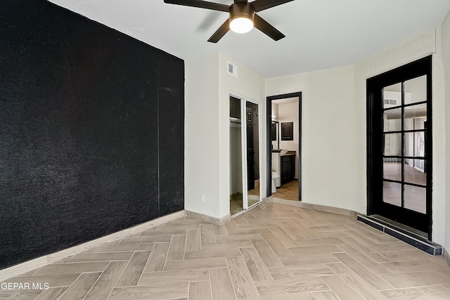 unfurnished room featuring a ceiling fan and visible vents