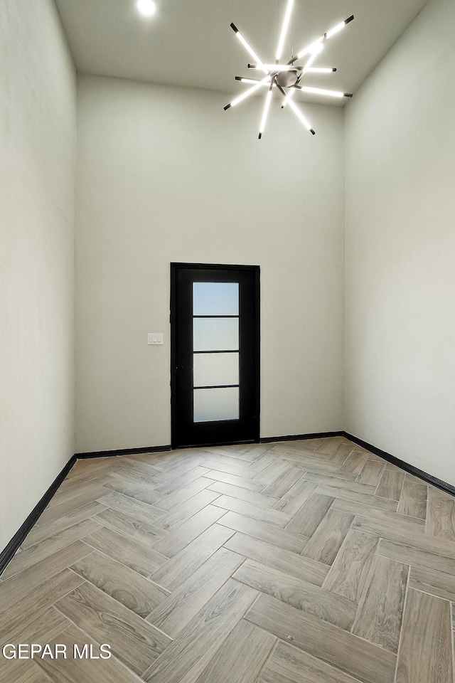 unfurnished room with baseboards