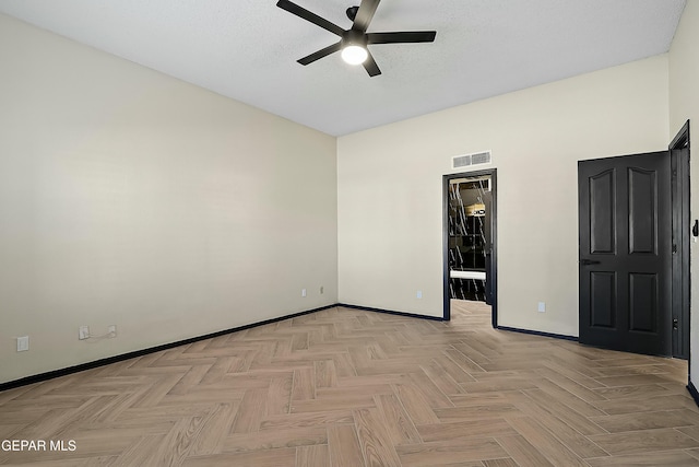 unfurnished bedroom featuring a textured ceiling, ensuite bath, visible vents, and baseboards