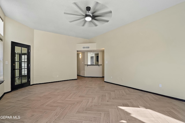 spare room featuring baseboards and visible vents