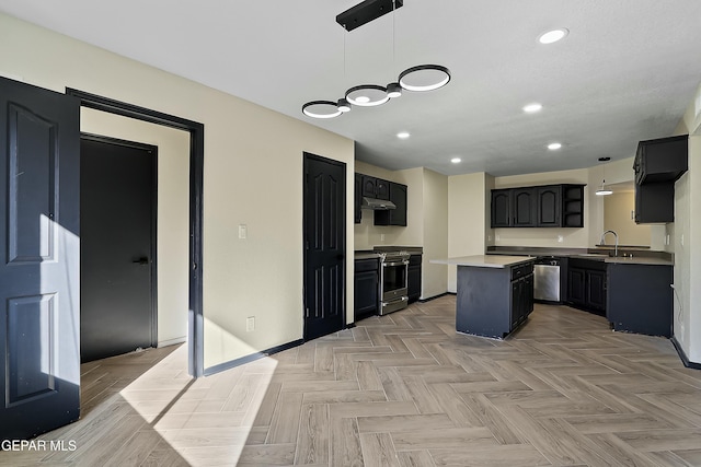 kitchen with appliances with stainless steel finishes, a kitchen island, hanging light fixtures, and a sink