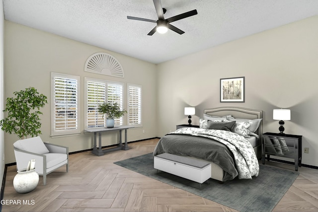 bedroom with a ceiling fan, baseboards, and a textured ceiling