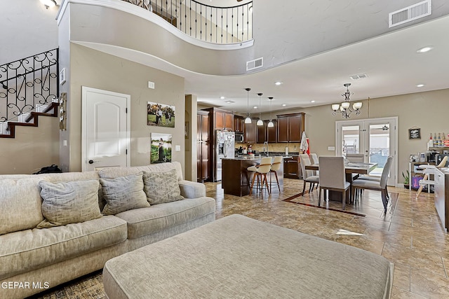 living room featuring visible vents, stairway, and recessed lighting