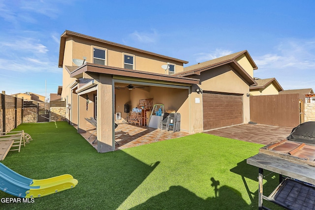 back of property with a yard, a patio, stucco siding, a ceiling fan, and a fenced backyard