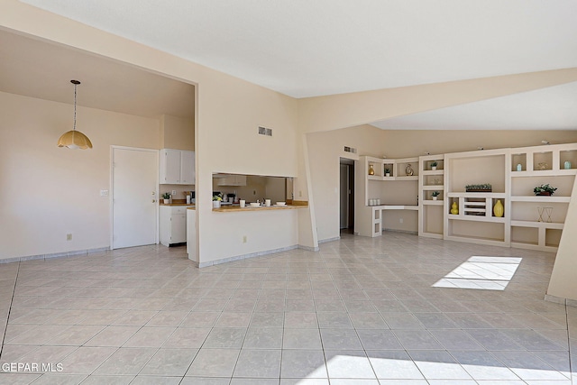 unfurnished living room featuring baseboards, visible vents, vaulted ceiling, and light tile patterned flooring