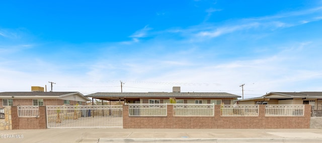 ranch-style house featuring driveway and a fenced front yard