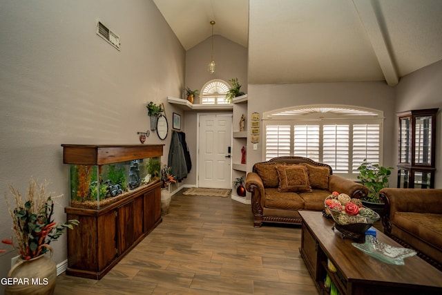 living area with high vaulted ceiling, wood finished floors, and baseboards