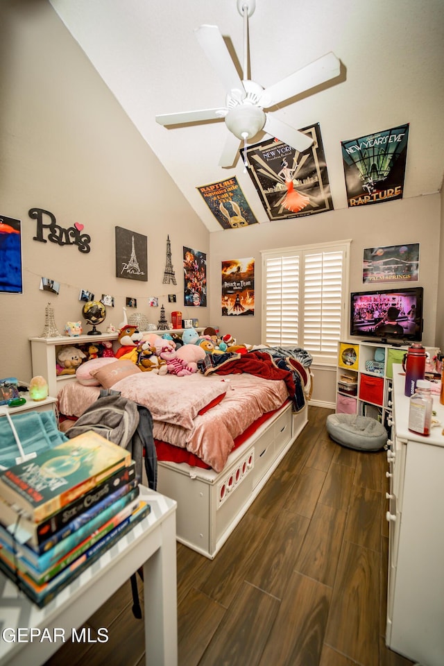 bedroom with a ceiling fan, lofted ceiling, and dark wood-style flooring