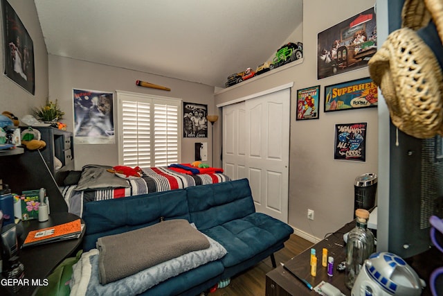 bedroom featuring a closet, baseboards, and wood finished floors