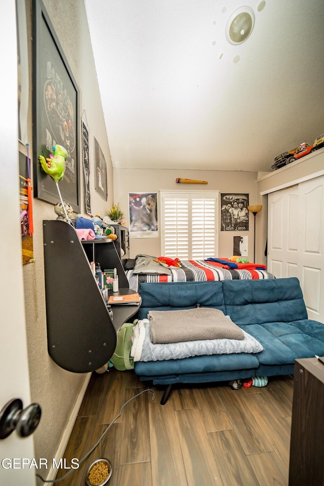 bedroom with a closet and wood finished floors