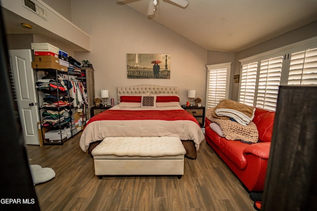 bedroom featuring a ceiling fan, dark wood-style flooring, and vaulted ceiling