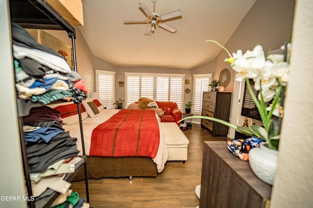 bedroom with vaulted ceiling and dark wood finished floors