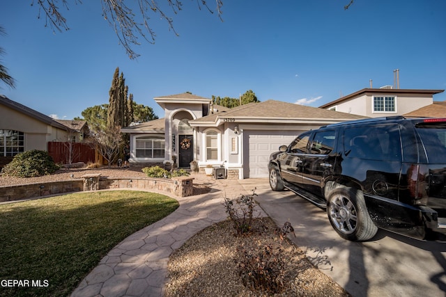 single story home featuring a garage, concrete driveway, fence, a front lawn, and stucco siding